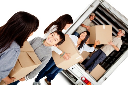 Professionals handling furniture pick-up in a storage facility in Bromley.