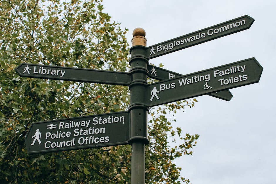 A green and white parking restriction sign mounted on a metal pole outdoors, indicating a two-hour parking limit from 8 am to 8 pm, Monday to Saturday, with exemptions on Sundays. The sign is position